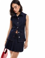 denim fitted waistcoat and pleated skirt